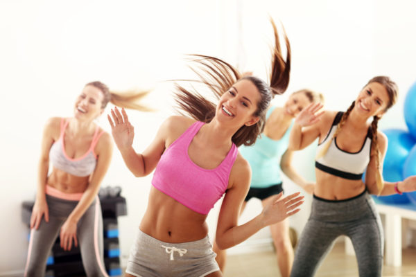 Group of happy people with coach dancing in gym Group of energetic people with coach dancing in gym